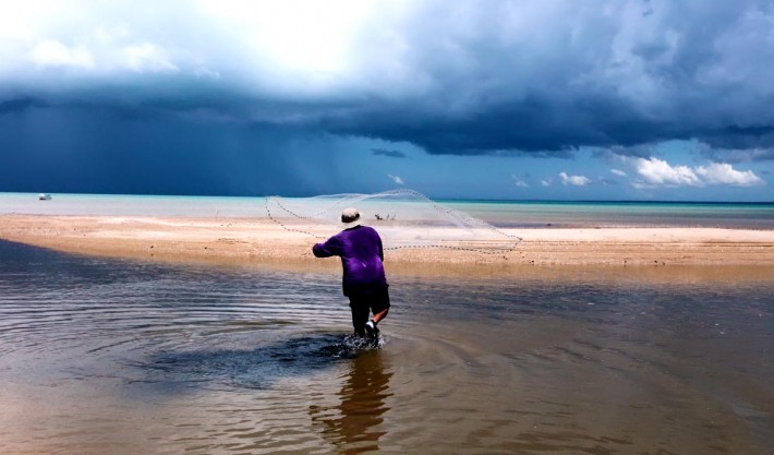 Storm clouds on the horizon while throwing the cast net